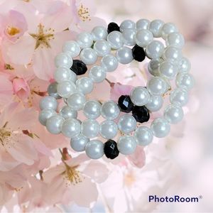 Set of 3 bracelets. White beads with 2 black beads in each